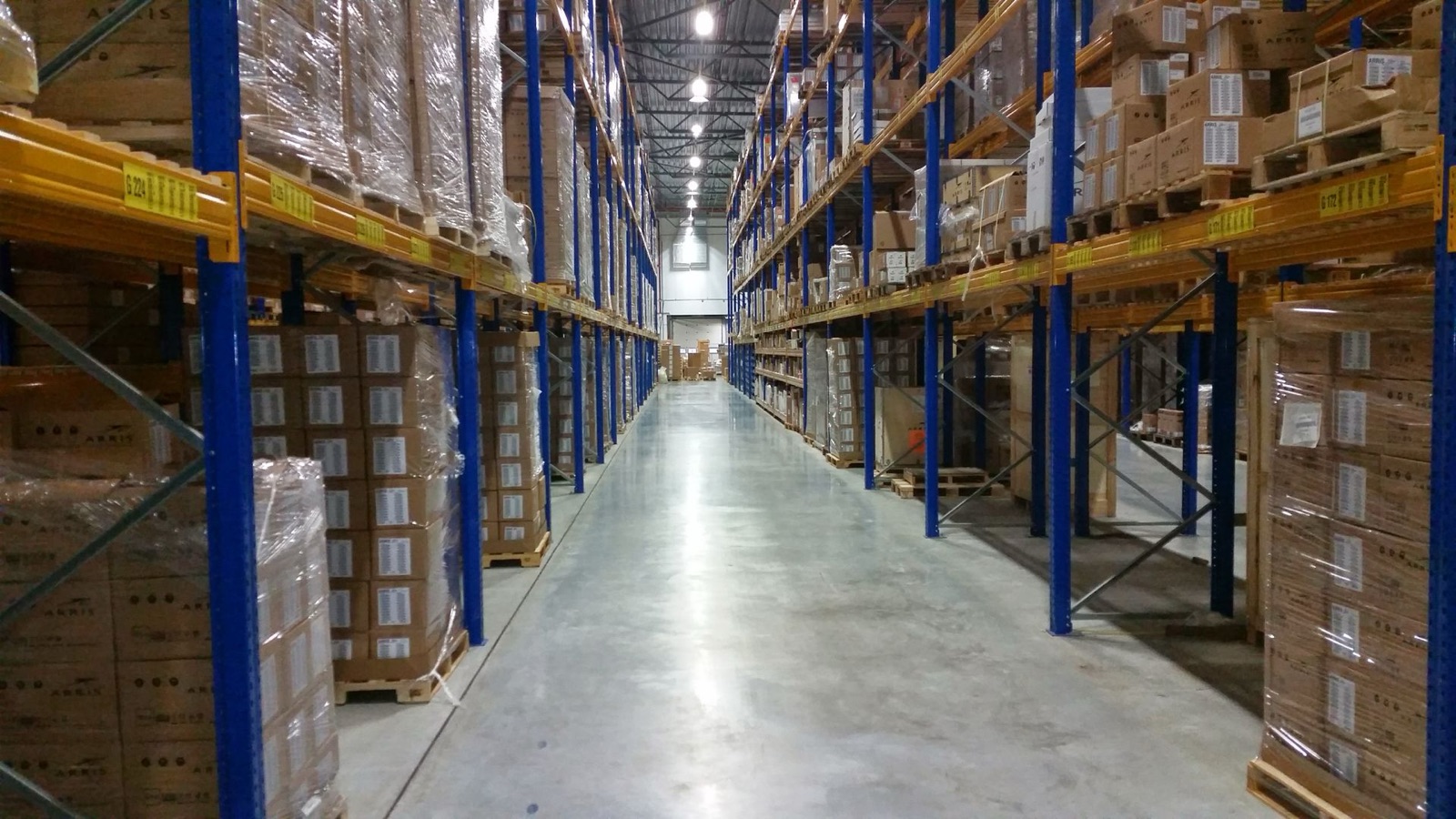 Fully stocked trade warehouse with floor-to-ceiling pallet racking